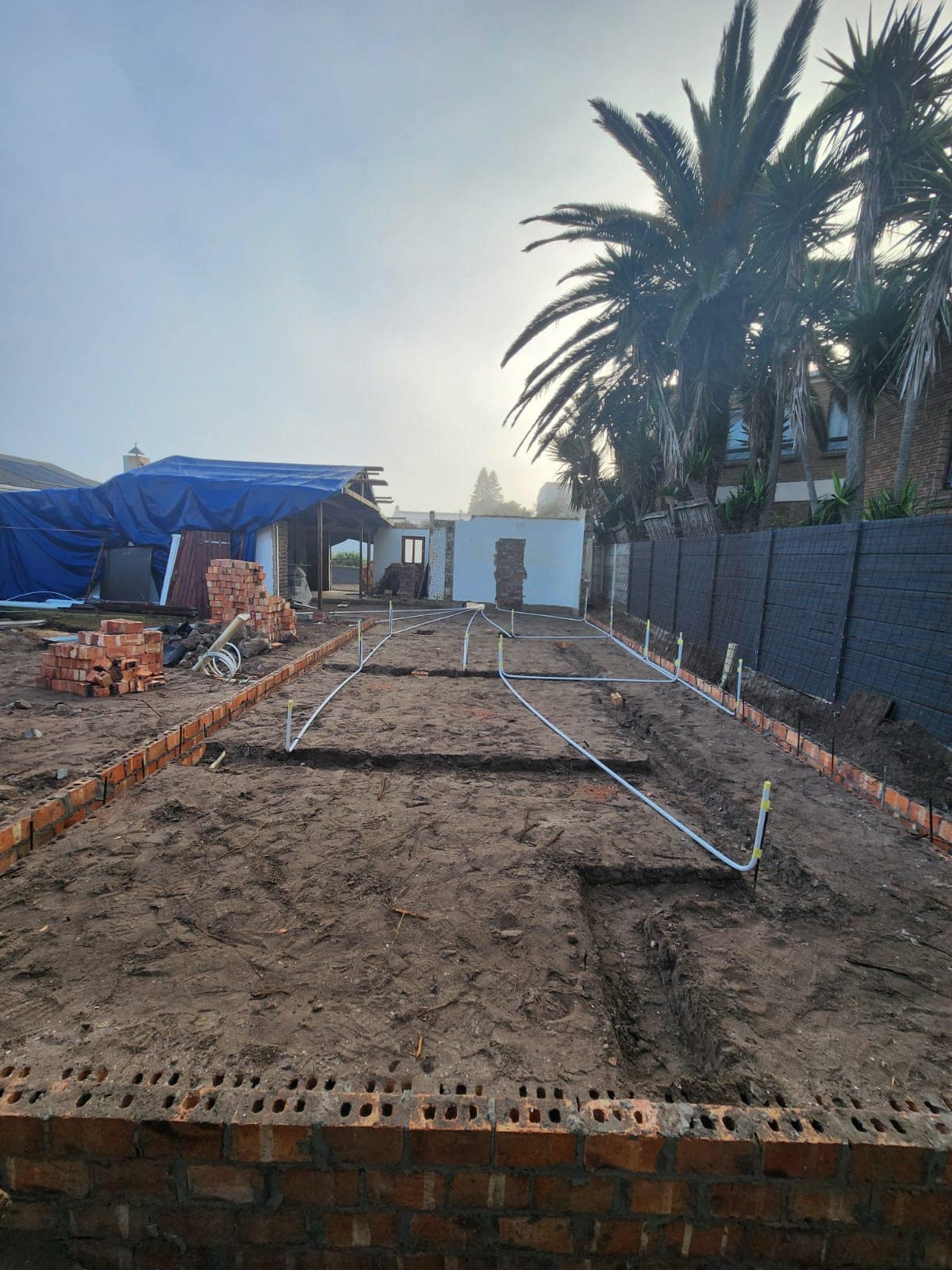 Drainage and water services set out across the foundations before casting